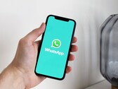 Hand die een smartphone vasthoudt met de WhatsApp-app geopend