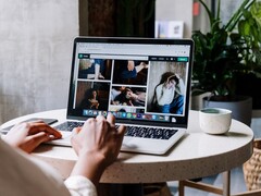 Iemand die op een laptop typt in een café, met op het scherm een browservenster met tabbladen en een adresbalk
