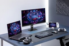 De Asus XG27UCMG-gamingmonitor naast diverse andere elektronische apparaten van Asus