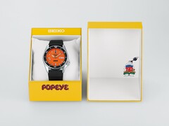 Seiko 5 Sports x Popeye HDB013 automatisch horloge met een oranje wijzerplaat, naast de gele presentatiedoos in beperkte oplage.